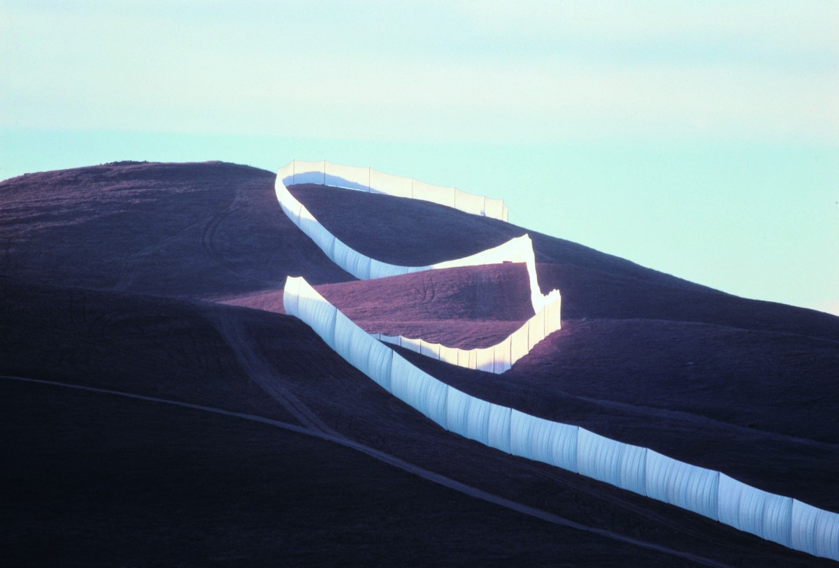 The Running Fence follows the contours of the land as it rises to cross a ridge. Photo must be credited to Wolfgang Volz, copyright Christo 1976. From a large-format color transparency lent by Christo and Jeanne-Claude.