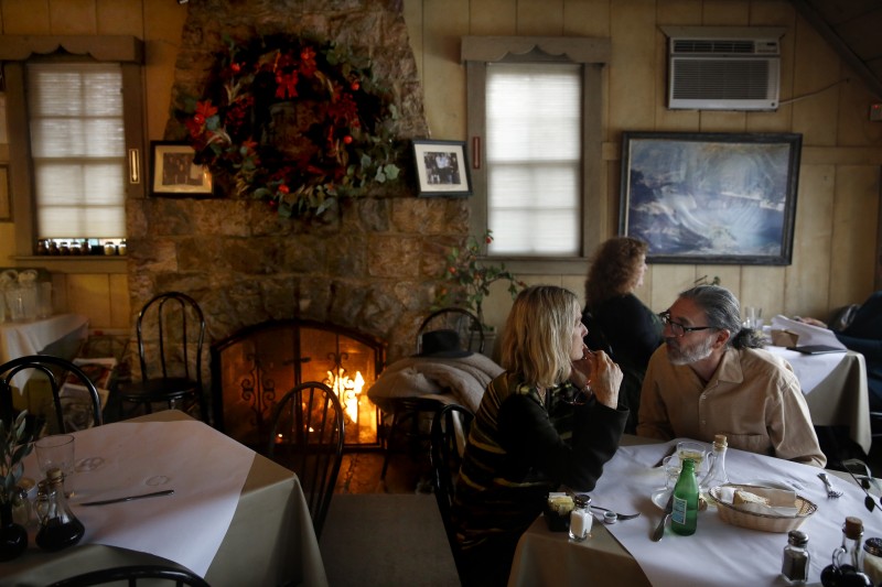 A fire burns in the dining room of Cafe Citti in Kenwood, on Monday, December 21, 2015. (BETH SCHLANKER/ The Press Democrat)
