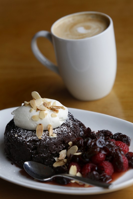 Flourless chocolate cake with dried cherry compote, fresh raspberries, whipped creme fraiche sprinkled with sliced almonds at The Spinster Sisters in Santa Rosa, on Thursday, December 8, 2016. (BETH SCHLANKER/