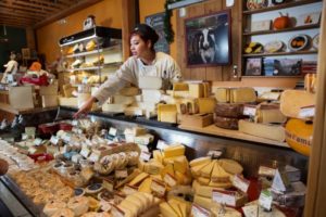 Cowgirl Creamery employee Erica Martinez helps a customer at Cowgirl Creamery at the Tomales Bay Foods in Point Reyes Station, Calif. (Photo by Charlie Gesell) 