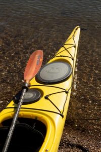 A colorful kayak rests at the edge of Tomales Bay at Blue Waters Kayaking's Marshall location. (Photo by Charlie Gesell) 