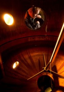 Timo Marshall adds juniper berry to gin in the handmade copper hybrid pot still at the Spirit Works distillery in Sebastopol. (photo by John Burgess)