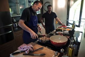 Chef Charlie Palmer deglases his cooked pheasant at his house with Dustin Valette, chef at Dry Creek Kitchen. (photo by Chris Hardy)