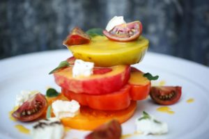 Executive chef John Toulze prepares an heirloom tomato salad at The Girl and the Fig in Sonoma. (Conner Jay/The Press Democrat)