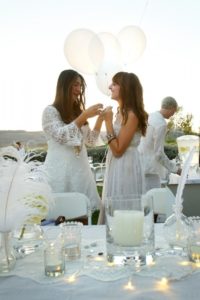 Fabiola Sotomayor and Emily Mughannam prepare their picnic table for the PopUp Dinner in White Wine Country in Sonoma on Saturday, October 19, 2013. (Conner Jay/The Press Democrat)