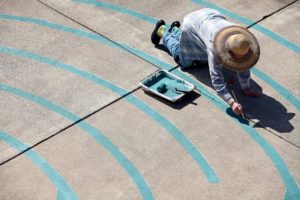 Joanne Page helps paint the Santa Rosa Labyrinth, designed by Lea Goode-Harris, in the courtyard of Christ Church United Methodist, in Santa Rosa.