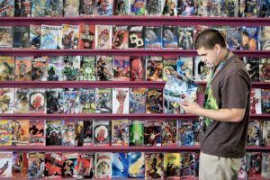 Joe Robledo searches for several of his favorite comic series he buys each week at Outer Planes Comics. (photo by Conner Jay)