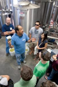 Tour guide Lewis Norvell talks about hops during a tour of the brewery at Lagunitas brewery, the first stop on a beer tour for the day with North Bay Brewery Tours. (photo by Scott Manchester)