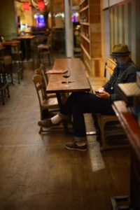 A bar patron enjoying a glass of red wine before a free screening of Alfonso Cuarón's film "Gravity".