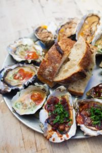 A plate of raw and cooked oysters is served at the Marshall Store in Marshall. (photo by Charlie Gesell)