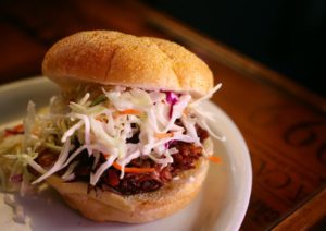 The house pulled pork sandwich with Asian slaw and sweet fries is served at Bruno's on Fourth in Santa Rosa.  (photo by Conner Jay)