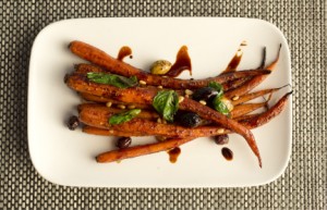 Moroccan-Style Lamb Chops on Couscous with Slivered Almonds and Tunisian Roasted Carrots with Pine Nuts, Olives and Mint at Willi’s Wine Bar.