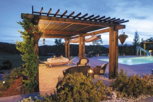 The arbor is a favorite setting for poolside dining and conversation, with a sandbox floor made for wiggling toes.