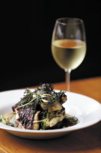  A half-chicken is served over bulghur with spigariello greens and Jerusalem artichokes at The Kenwood Restaurant. (Beth Schlanker)