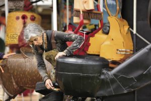 Amiot's wife and lontime collaborator, Brigitte Laurent, applies finishing touches to a giant phone. She paints all of Amiot's creations by hand.