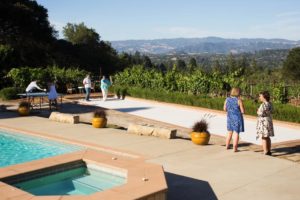 Guests play games and take in the view of the surrounding hills in Daryl and Lisa Groom's backyard.