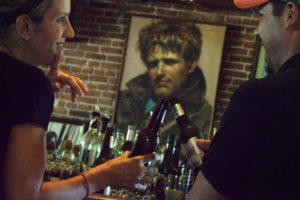 Bar patrons Jen and Mike Mettler, tourists visiting from Clements, California, drinking beer under an image of Jack London at the Jack London Saloon in Glen Ellen.