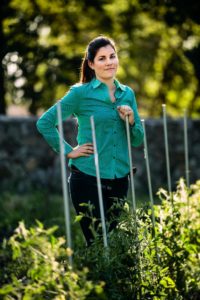 Andrea Davis-Cetina of Quarter Acre farm with some tomato plants.