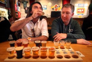 Cristian Jara Villegas, left, and Jay Fellers share a sampler flight of beers at Russian River Brewing Company in Santa Rosa. (photo by Christopher Chung)