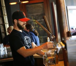 Josh Hamilton pours a beer for the Friday crowd at Fogbelt Brewing Company in Santa Rosa. (photo by Connor Jay)