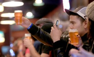 Sebastian Hernandez of Rancho Cucamonga photographs a glass of Pliny the Younger at The Russian River Brewing Co. in Santa Rosa, Friday Feb. 7, 2014. (Kent Porter / Press Democrat)