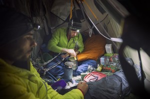 Tommy Caldwell and Kevin Jorgeson free climbing El Capitan's Dawn Wall. Big-wall chef Tommy Caldwell cooks up some gruel on his hanging propane stove in his portaledge camp 1,200 feet up the side of El Capitan. (photo by Corey Rich)