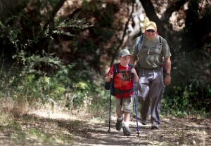 Ari Castaneda, 8, and his dad, Paul, hike towards an overnight campground where they will be spending the night at Hood Mountain Regional Park in Kenwood. (Photo by Beth Schlanker)