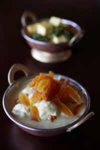 Lamb and apricot curry, front, and saag paneer, cheese with spinach, rear, at Marigold Indian Bistro in Sebastopol. (Photo by Beth Schlanker)