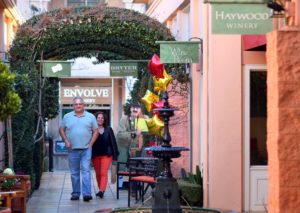 Ernesto and Diana Crespo walk through the Sonoma Court Shops, which include numerous tasting rooms, in Sonoma. (Photo by Christopher Chung)