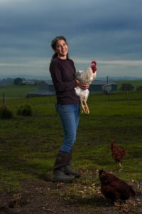 Dawn Dolcini of Tully Dolci Organic Farm holds a Leghorn rooster.