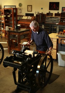 Eric Johnson prints announcements for an upcoming show on an authentic platen press circa 1930 at Iota Press in Sebastopol. 