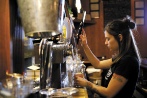 Bartender Cheryl Avery pours a pint of beer at Taps Restaurant and Tasting Room in Petaluma. (photo by Beth Schlanker)