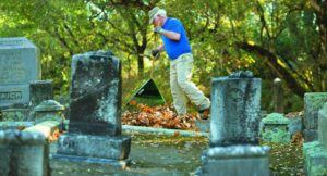 Henry Katz clears leaves from a work site.