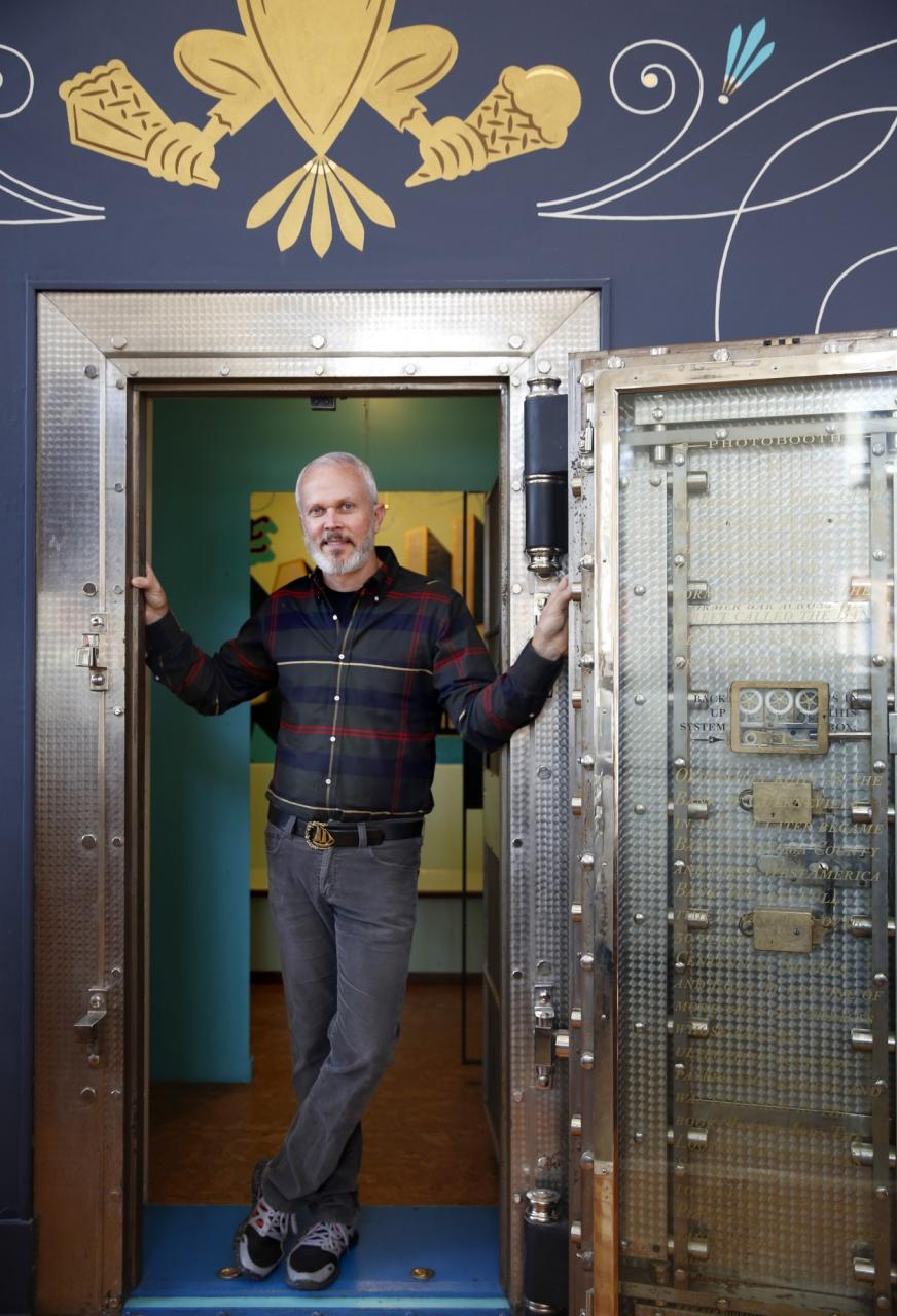 Bob Pullum, the owner of Guerneville Bank Club, stands next to the old vault inside the building. (BETH SCHLANKER/ The Press Democrat)