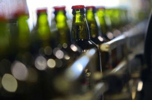 Freshly filled bottles of cider make their way down the production line at Sonoma Cider in Healdsburg, on Tuesday, March 1, 2016.   (Christopher Chung/ The Press Democrat)