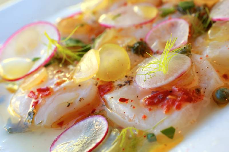 Cured scallops with grapes, radish, lime and Calabrian chiles at Hazel in Occidental. ( John Burgess / The Press Democrat)
