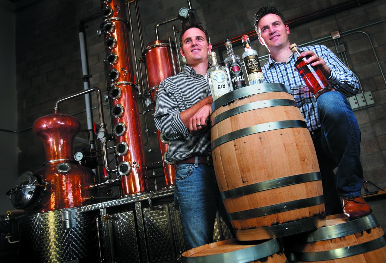 Twin brothers Chris, left, and Brandon Matthies own and operate Sonoma Brothers Distilling, in Windsor. The brothers produce gin, vodka and whiskey in their handmade Arnold Holstein copper pot still. (Photo by Christopher Chung)