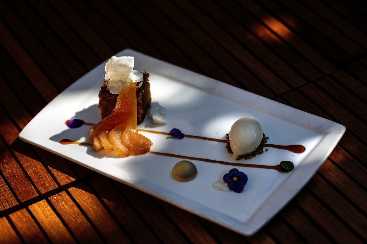 Scott Noll’s “Milk & Honey”: honey-pickled poached pear against honey tea cake near dehydrated “crunchy” milk with honey ice cream sitting on bee pollen.