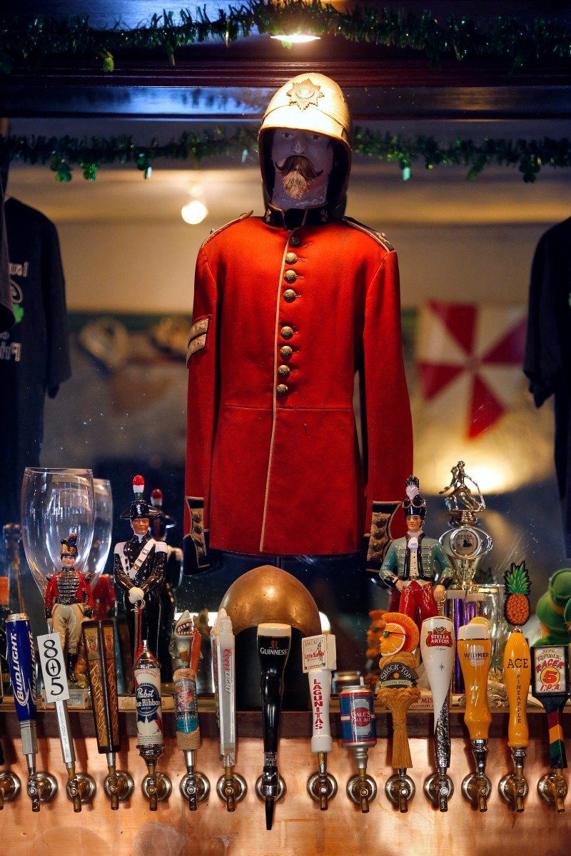 An Irish Guards uniform tunic and other Irish-themed decorations stand above the beer tap during a football game between the Miami Dolphins and Atlanta Falcons at Friar Tucks Pub in Cotati, California on Thursday, August 25, 2016. (Alvin Jornada / The Press Democrat)