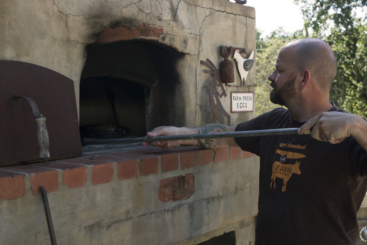 John Stewart cooking with his wood-fired oven at his home in Forestville, California. June 18, 2016. (Photo: Erik Castro/for Sonoma Magazine)