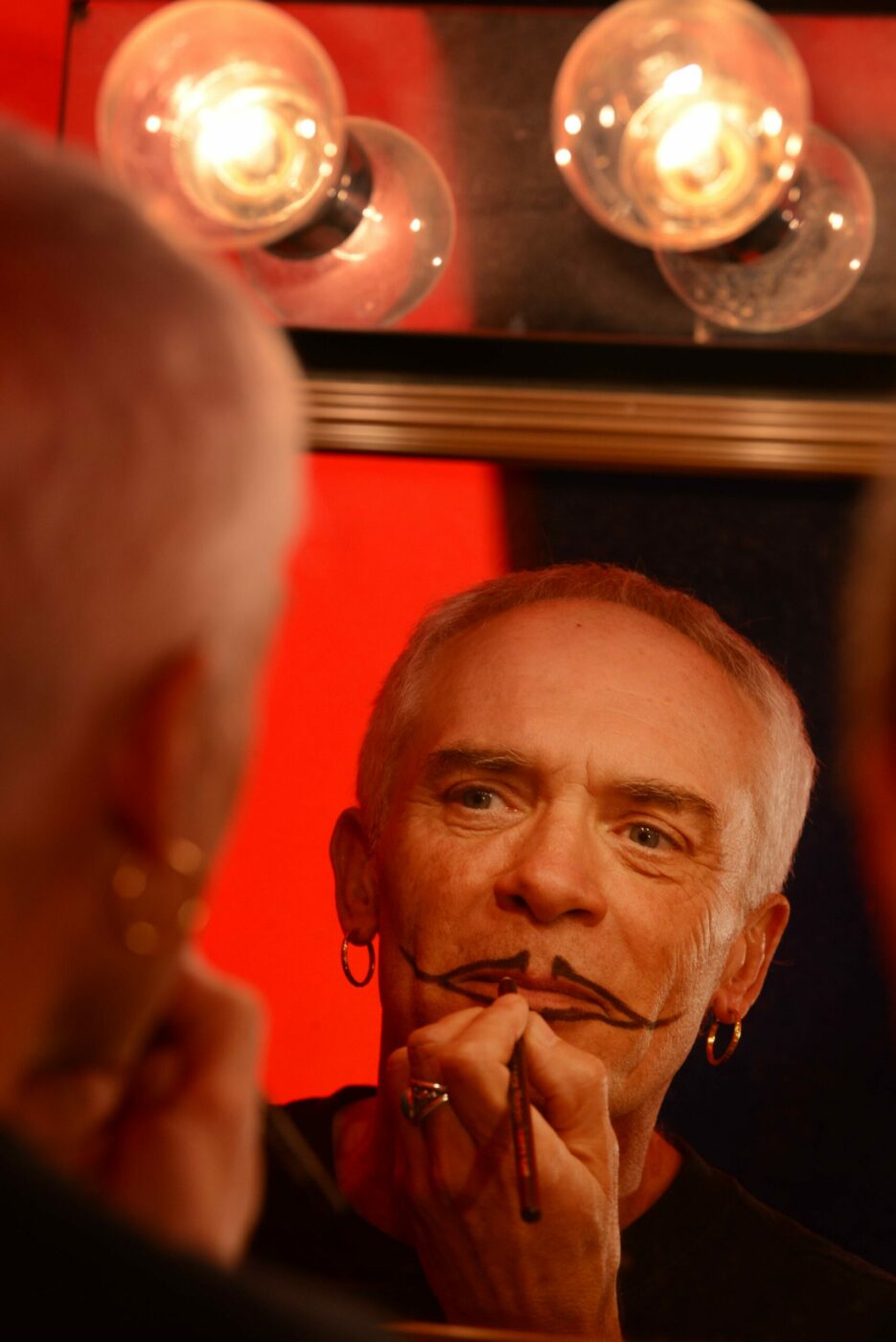 Backstage circus performer and show writer/producer Michel Michelis prepares his makeup before a performance of Cirque de Boheme, an old style circus based on the French tradition of the 1920's held Sunday at Cornerstone Sonoma. (Erik Castro/for The Press Democrat)