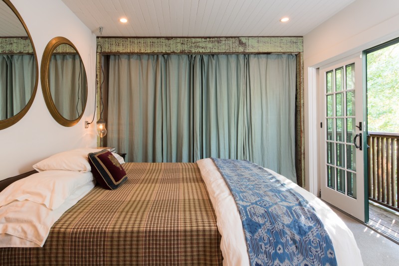 The master bedroom with sliding French doors that open to the view.