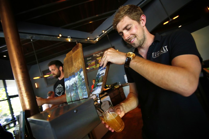 Fraser Ross pours a beer for the Friday crowd at Fogbelt Brewing Company in Santa Rosa, June 27, 2014. (Conner Ja