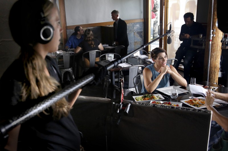 Actress Dorian Brown preps for a scene as boom operator Corryn Deegan checks the sound during filming of the movie "Running Wild" at the The Pullman Kitchen in Santa Rosa, on Monday, August 17, 2015. (BETH SCHLANKER/