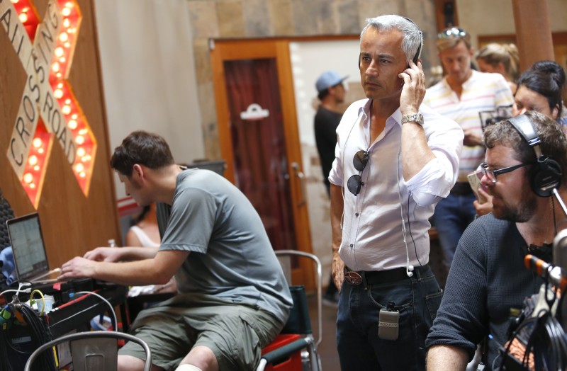 Ali Afshar, the executive producer, monitors a scene being filmed from the movie "Running Wild" at the The Pullman Kitchen in Santa Rosa, on Monday, August 17, 2015. (BETH SCHLANKER/ The Press Democrat)
