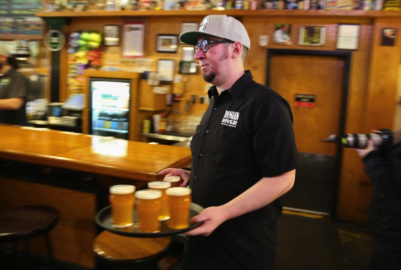 First things first: order your pints! Rounds of Younger all around when people enter the pub. (Photo by Tim Vallery) Server Grant Baker brings out a tray of Pliny the Younger at the Russian River Brewing Company, in Santa Rosa, on Friday, February 3, 2017. (Christopher Chung