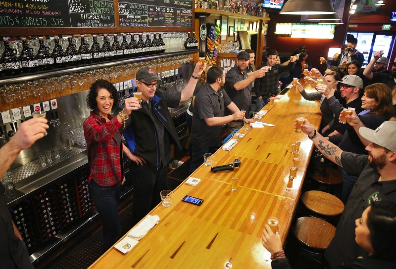 Russian River Brewing Company owners Natalie, left, and Vinnie Cilurzo raise glasses of Pliny the Younger with their staff before opening their doors to customers in Santa Rosa, on Friday, February 3, 2017. (Christopher Chung