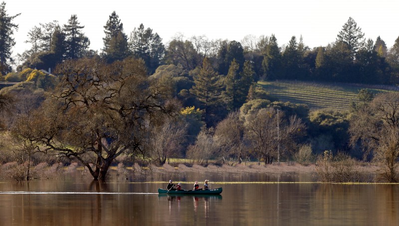 The Niklasson family, from left, Johan, Tindra, 11, Freja, 13, and Courtney paddle their canoe on the Laguna de Santa Rosa, north of Occidental Road, which has swollen from recent rainfall, in Santa Rosa, California on Saturday, February 11, 2017. (Alvin Jornada