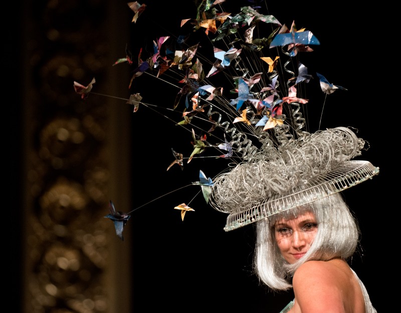 Lauren Benward-Krause models a hat made from a rotating fan, recycled wire and origami birds from old magazine pages, designed by Joni Derickson and Alexa Wood, during the Trashion Fashion Show, where designers create outfits out of recycled materials, at the Sonoma Community Center in Sonoma, Calif., on April 26, 2013. (Alvin Jornada 
