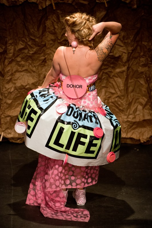 Model Kelly Rose Gibbons wears designer Marcy Waldron's "Recycle Yourself! Be an Organ Donor" dress, made of a plastic table cloth, candy wrappers and plastic cup lids painted pink to represent the donor dot on a driver's license, during the Trashion Fashion Show, where designers create outfits out of recycled materials, at the Sonoma Community Center in Sonoma, Calif., on April 26, 2013. (Alvin Jornad